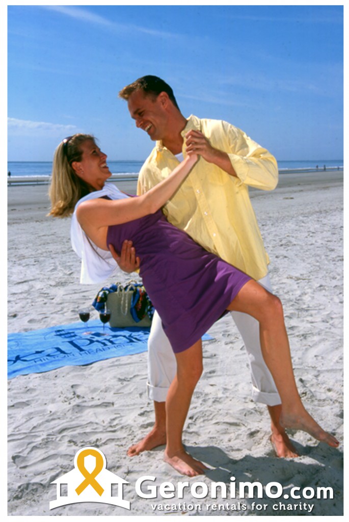 happy couple dancing on beach